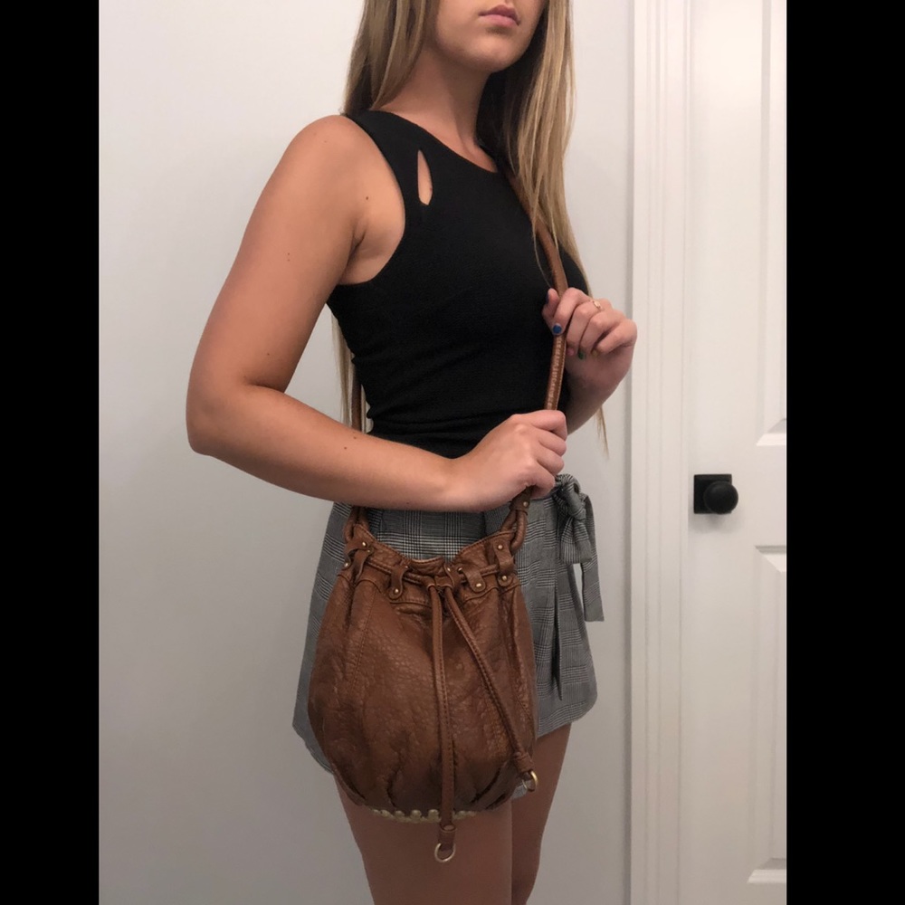 Leather crossbody bag with studded bottom